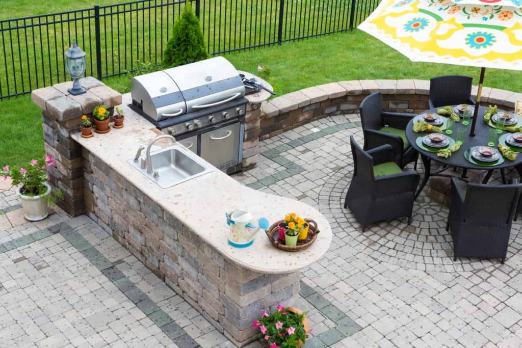 Outdoor grill with countertop, sink, and table