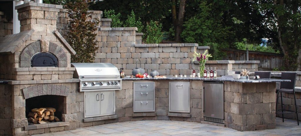 Outdoor grill with countertop, drawers, wood fire pizza oven